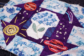 Embroidered quilt square with intricate blue hydrangeas and cosmic imagery of planets